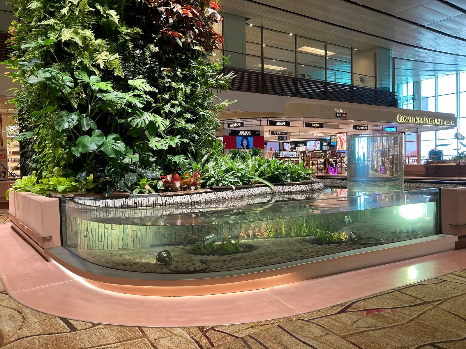 Curved acrylic viewing panel to the landscaped pond at Changi Airport Terminal 1